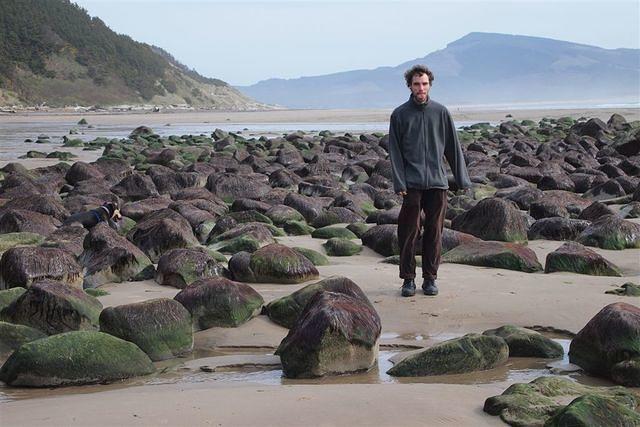 Jeff in a field of mossy rocks